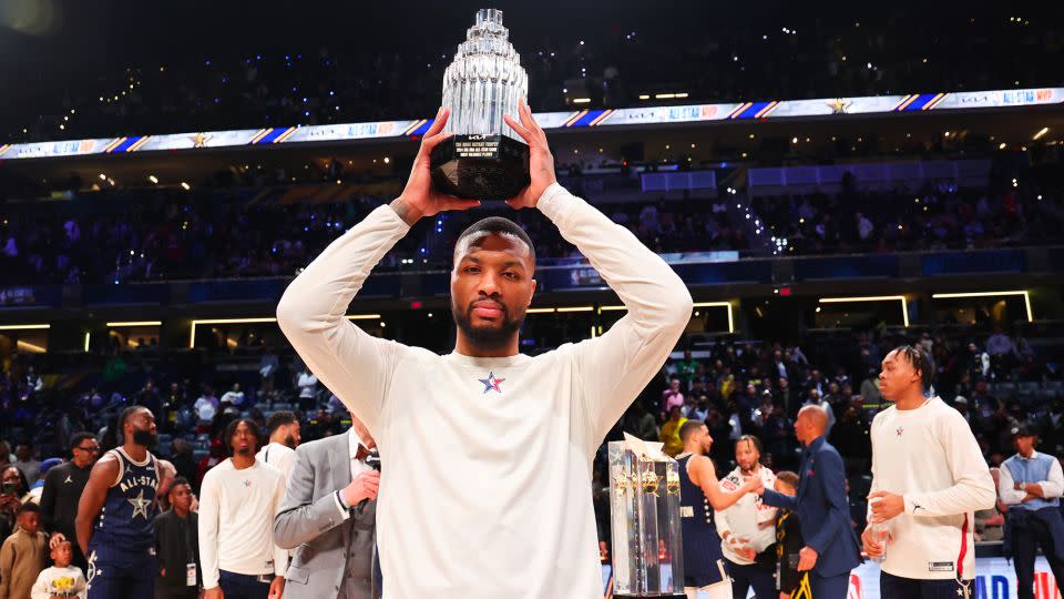 Lillard lifts the Kobe Bryant All-Star MVP trophy. - Stacy Revere/Getty Images