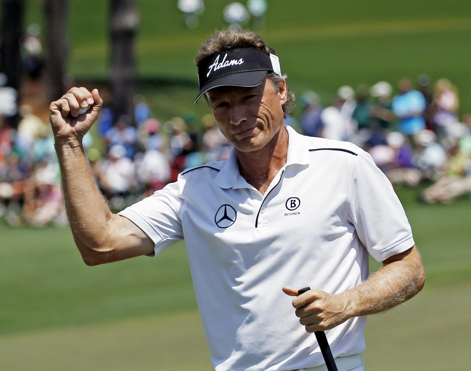 Bernhard Langer, of Germany, holds up his ball after an eagle on the second hole during the fourth round of the Masters golf tournament Sunday, April 13, 2014, in Augusta, Ga. (AP Photo/Matt Slocum)