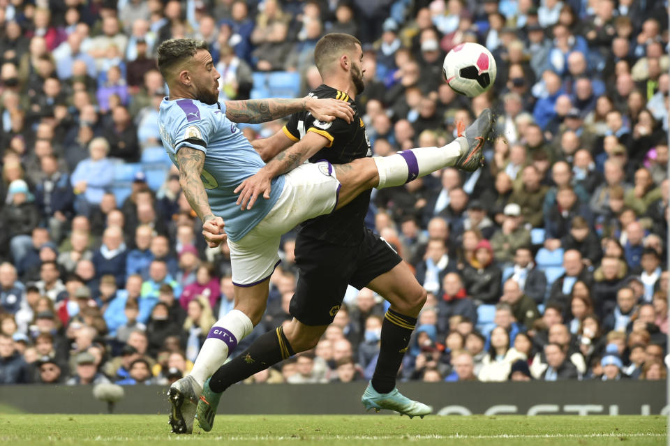 Manchester City's Ilkay Gundogan, left, and Wolverhampton Wanderers' Patrick Cutrone battle for the ball during the English Premier League soccer match between Manchester City and Wolverhampton Wanderers at Etihad stadium in Manchester, England, Sunday, Oct. 6, 2019. (AP Photo/Rui Vieira)