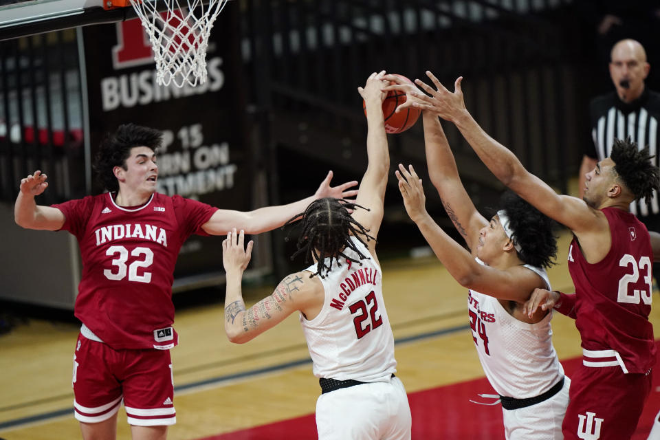 Rutgers guards Caleb McConnell (22) and Ron Harper Jr. (24) strip the ball from Indiana guard Trey Galloway (32) as Galloway tries to pass to forward Trayce Jackson-Davis (23) during the second half of an NCAA college basketball game, Wednesday, Feb. 24, 2021, in Piscataway, N.J. (AP Photo/Kathy Willens)