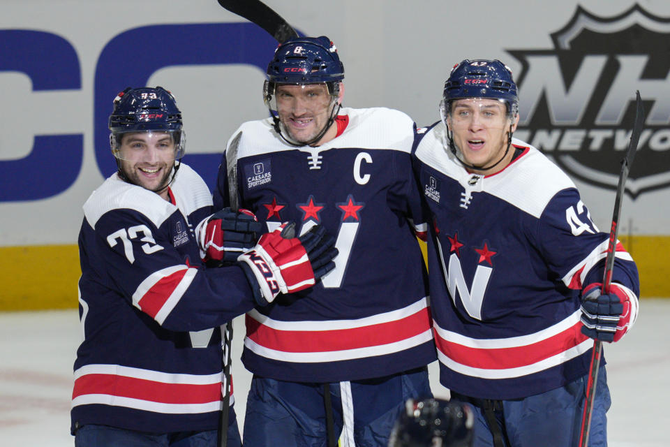 Washington Capitals left wing Alex Ovechkin (8), center, celebrates his goal with left wing Conor Sheary (73) and defenseman Martin Fehervary (42) during the third period of an NHL hockey game against the Vancouver Canucks, Monday, Oct. 17, 2022, in Washington. (AP Photo/Jess Rapfogel)