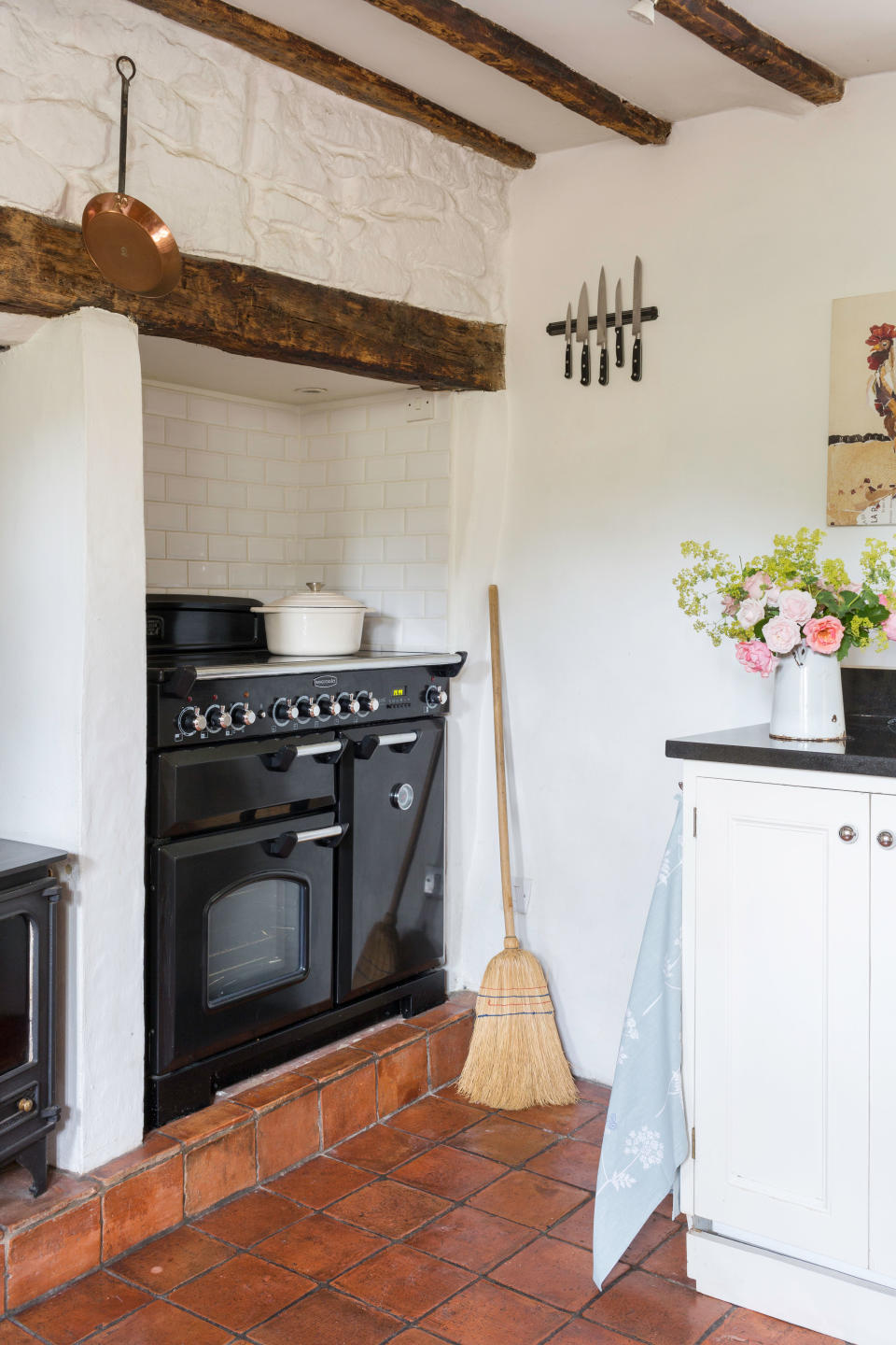 17. Make a traditional white kitchen feel warmer with terracotta tiles