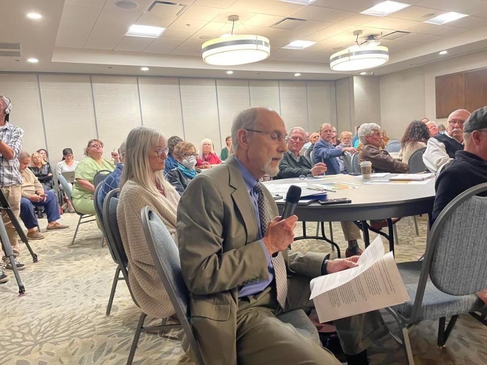 Robert Kline, a longtime doctor in the Asheville community, reads a letter signed by 48 doctors during the public comment period. Eight of the doctors signed anonymously.