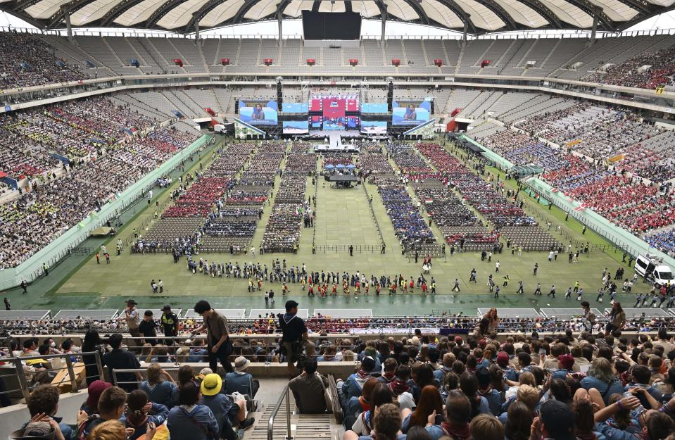 Attendees of the World Scout Jamboree attend the closing ceremony of the World Scout Jamboree at the World Cup Stadium in Seoul, South Korea, Friday, Aug. 11, 2023. Flights and trains resumed and power was mostly restored Friday after a tropical storm blew through South Korea, which was preparing a pop concert for 40,000 Scouts whose global Jamboree was disrupted by the weather. (Korea Pool via AP)