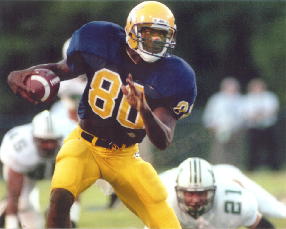 In this undated photo provided by the University of Tennessee Chattanooga athletic department, wide receiver Terrell Owens (80) plays in an NCAA college football game for the school. Owens will be giving his Hall of Fame induction speech at the University of Tennessee at Chattanooga on Saturday, Aug. 4, 2018, where he played college football, rather than appearing at the ceremony in Canton with his fellow honorees. (UTC Athletics via AP)