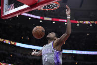 Sacramento Kings' De'Aaron Fox dunks against the Chicago Bulls during the first half of an NBA basketball game Wednesday, March 15, 2023, in Chicago. (AP Photo/Charles Rex Arbogast)