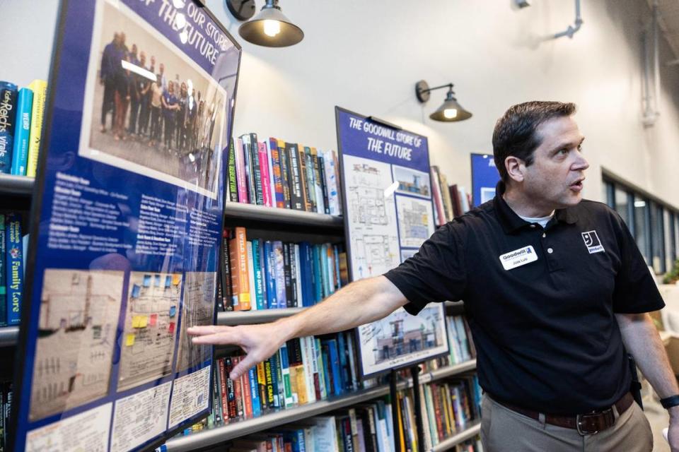 Goodwill Industries of the Southern Piedmont Chief Operating Officer Jose Luis points to illustrations Tuesday during a tour of the new store prototype opening Friday, Jan. 19, 2023, in Steele Creek.