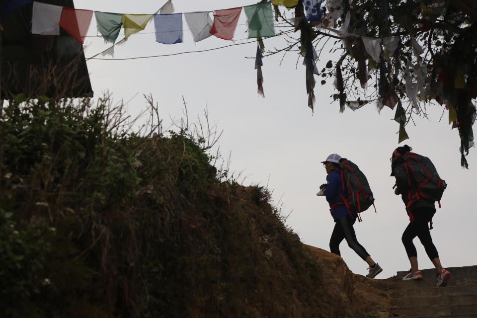 In this photo taken Saturday, March 30, 2019, Nima Doma, 34, right, and Furdiki Sherpa, 43, perform morning exercises as they train to summit Mount Everest, in Kathmandu, Nepal. Five years after one of the deadliest disasters on Mount Everest, three people from Nepal's ethnic Sherpa community, including Doma and Sherpa, are preparing an ascent to raise awareness about the Nepalese mountain guides who make it possible for hundreds of foreign climbers to scale the mountain and survive. The two women lost their husbands in the 2014 ice avalanche on Everest’s western shoulder that killed 16 fellow Sherpa guides. (AP Photo/Niranjan Shrestha)