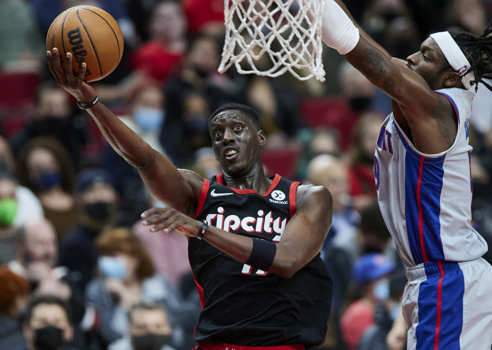 Portland Trail Blazers forward Tony Snell, left, shoots next to Detroit Pistons forward Jerami Grant during the second half of an NBA basketball game in Portland, Ore., Tuesday, Nov. 30, 2021. (AP Photo/Craig Mitchelldyer)