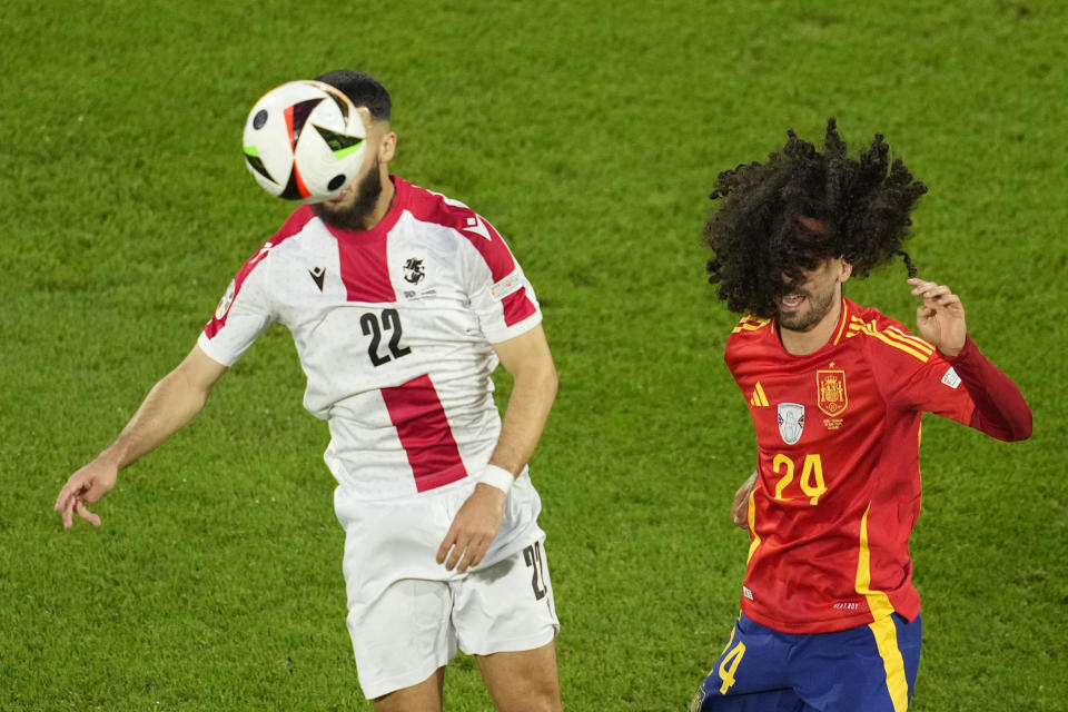 Georgia's Georges Mikautadze, left, fights for the ball with Spain's Marc Cucurella during a round of sixteen match between Spain and Georgia at the Euro 2024 soccer tournament in Cologne, Germany, Sunday, June 30, 2024. (AP Photo/Andreea Alexandru)