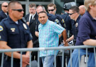 A man is detained by Anaheim Police officers outside the Anaheim Convention Center before Republican U.S. Presidential candidate Donald Trump speaks at a campaign event in Anaheim, California U.S. May 25, 2016. REUTERS/Mike Blake