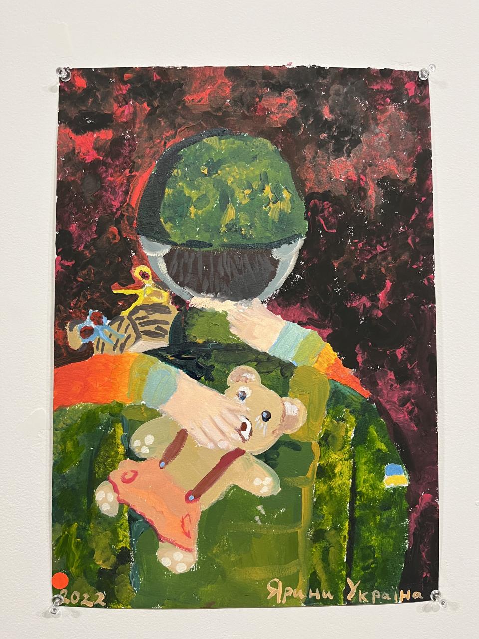 An artwork of a Ukrainian soldier carrying a child holding a teddy bear
