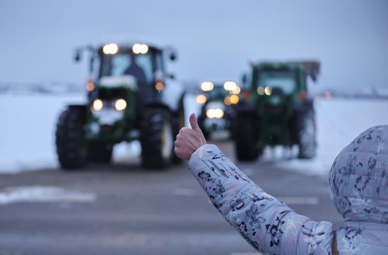 German farmers take part in a protest against the cut of vehicle tax subsidies