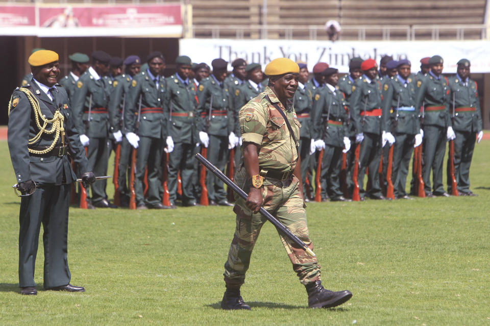 Soldiers laugh during rehearsals for Sundays inauguration of Zimbabwean President Emmerson Mnangagwas in Harare, Saturday, Aug, 25, 2018. Opposition leader Nelson Chamisa said he respectfully rejects the court ruling upholding Mnangagwas narrow election win. (AP Photo/Tsvangirayi Mukwazhi)