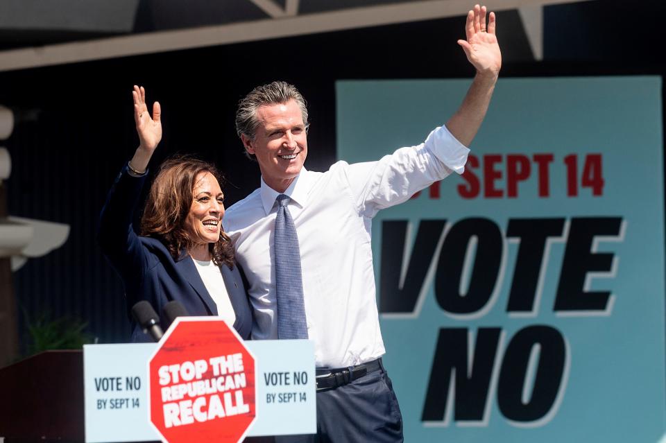 Vice President Kamala Harris and California Gov. Gavin Newsom wave to supporters on Wednesday during a rally against the California gubernatorial recall election in San Leandro, Calif.