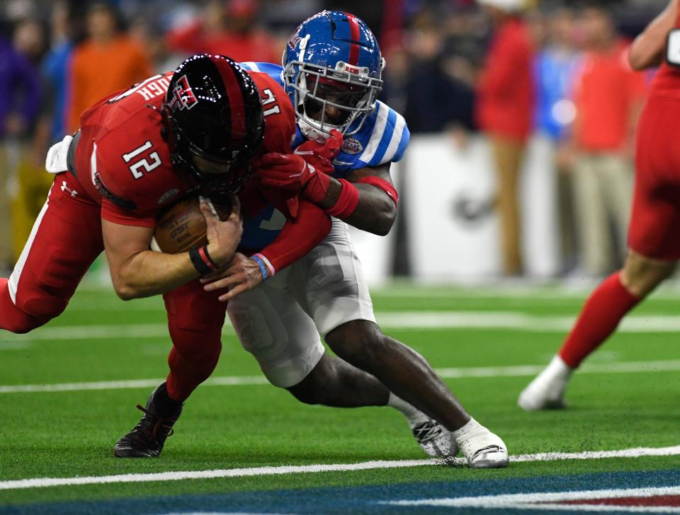 Texas Tech quarterback Tyler Shough (12) scores one of his two touchdowns in the Red Raiders' 42-25 victory Wednesday night against Mississippi in the Texas Bowl. Both TDs came on fourth-and-goal runs from the 2-yard line. Shough also had a 36-yard run and finished with a career-high 111 yards rushing.