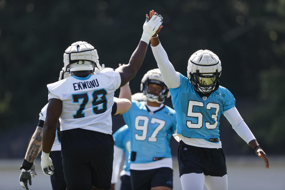 Carolina Panthers tackle Ikem Ekwonu (79) high-fives defensive end Brian Burns (53) at the NFL football team's training camp at Wofford College in Spartanburg, S.C., Thursday, July 28, 2022. (AP Photo/Nell Redmond)