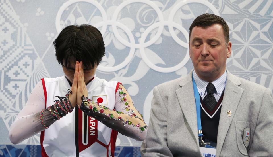 Japan's Yuzuru Hanyu reacts in the "kiss and cry" area during the Figure Skating Men's Free Skating Program at the Sochi 2014 Winter Olympics