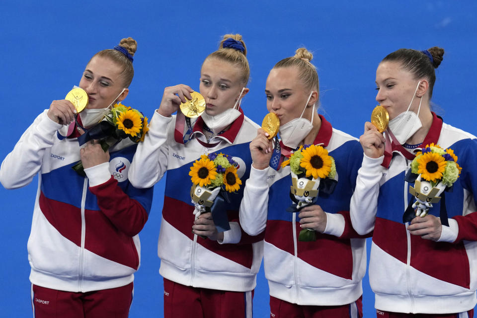 Russian Olympic Committee's artistic gymnastics women's team, from left, Liliia Akhaimova, Viktoriia Listunova, Angelina Melnikova and Vladislava Urazova celebrate after winning the gold medal at the 2020 Summer Olympics, Tuesday, July 27, 2021, in Tokyo. (AP Photo/Gregory Bull)