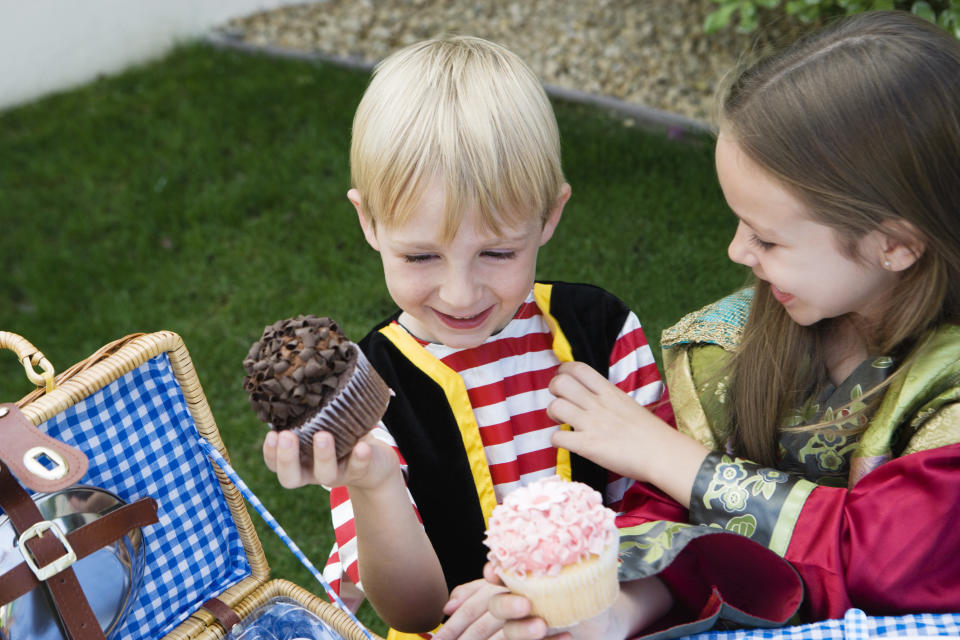 Stock image of a young boy and girl eating cupcakes. Source: AAP