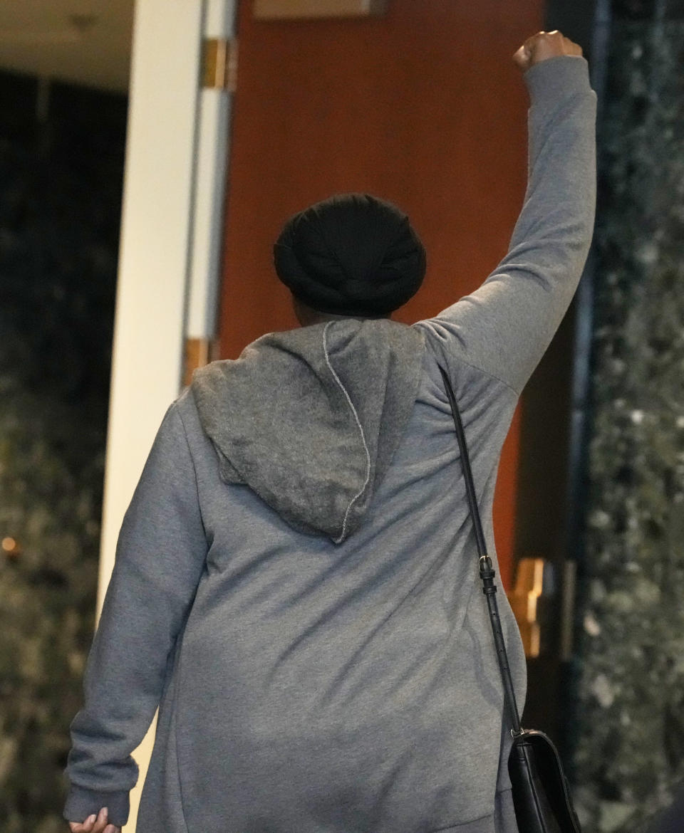 Sheneen McClain, mother of Elijah McClain, raises her arm as she leaves the courtroom after hearing the verdict in the trial involving the 2019 death of her son on Thursday, Oct. 12, 2023, in Brighton, Colo. (AP Photo/David Zalubowski)