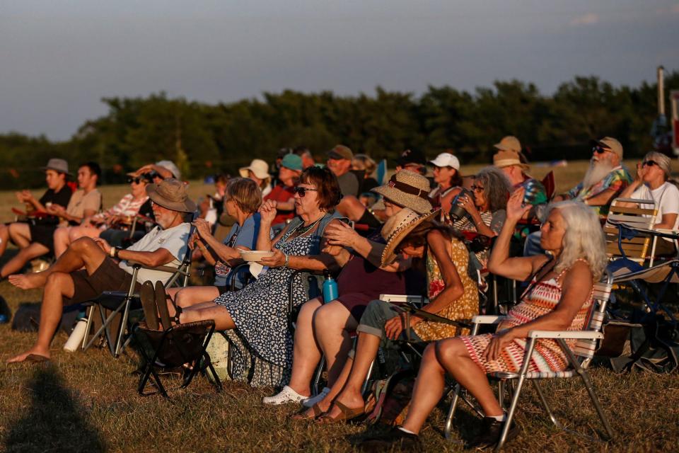 Attendees gather in the Pastures of Plenty to listen to the main stage performances WoodyFest 2022 in Okemah, Okla. on Thursday, July, 14, 2022. 