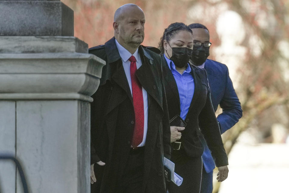 FILE - Betsy Segui, center, and Luis Rivera, right, enter the courthouse in New Haven, Conn., Thursday, Dec. 8, 2022. Five Connecticut police officers pleaded not guilty Wednesday, jan. 11, 2023, to charges accusing them of cruelly mistreating a Black man after he was partially paralyzed in a police van with no seat belts when the driver braked hard. The New Haven officers entered the pleas during their second appearances in state court since being arrested in November in connection with the injuries suffered by Richard "Randy" Cox, who is paralyzed from the chest down. (AP Photo/Seth Wenig, File)