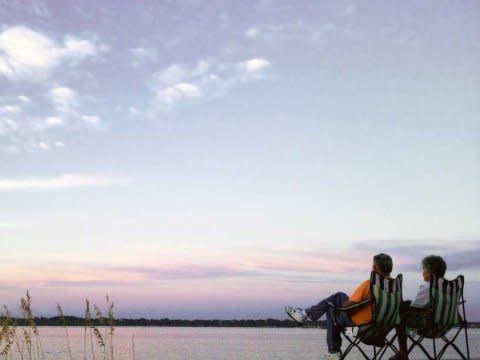 older couple by water sunset