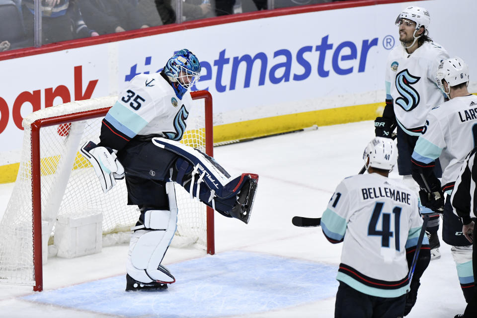 Seattle Kraken goaltender Joey Daccord (35) and teammates celebrate a win against the Winnipeg Jets in an NHL hockey game Tuesday, March 5, 2024, in Winnipeg, Manitoba. (Fred Greenslade/The Canadian Press via AP)