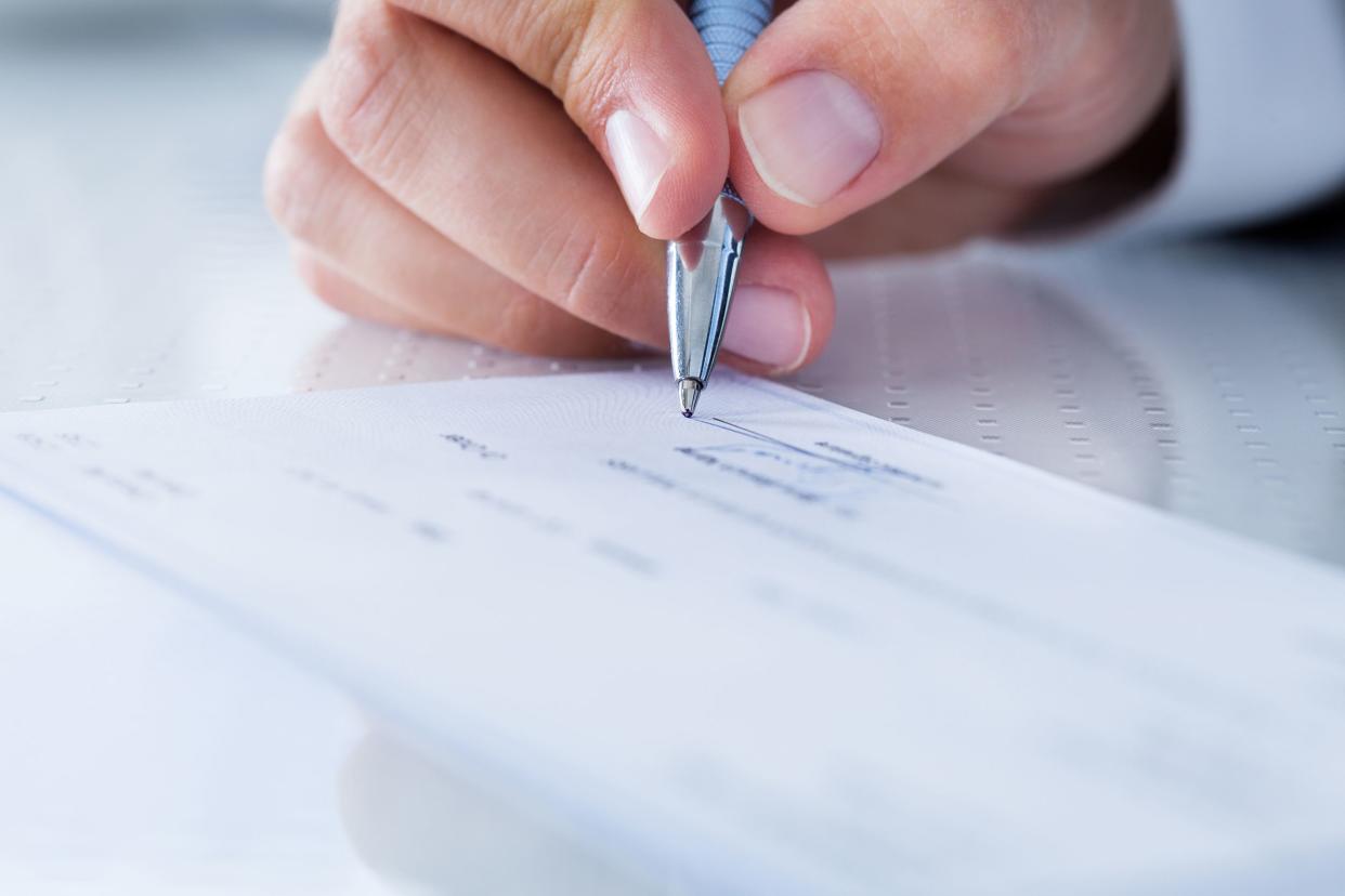 close-up of hand filling cheque