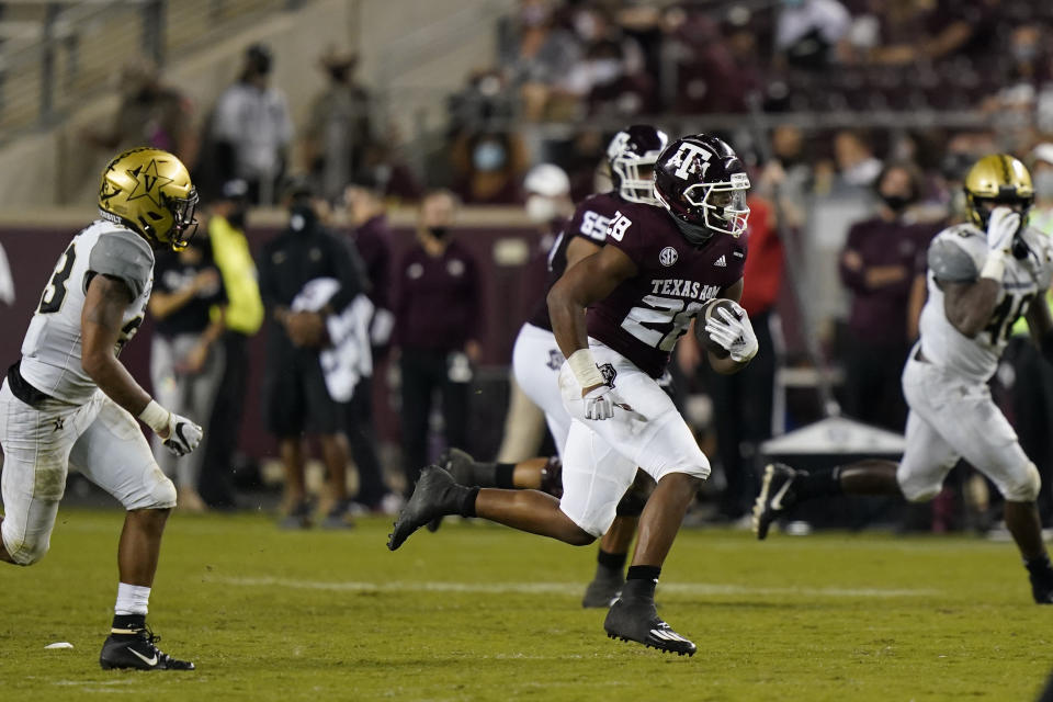 Texas A&M running back Isaiah Spiller (28) rushes for a first down against Vanderbilt during the second half of an NCAA college football game Saturday, Sept. 26, 2020, in College Station, Texas. Texas A&M won 17-12. (AP Photo/David J. Phillip)