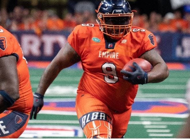 Mykel Benson carries the ball for the Albany Empire of the Arena League.