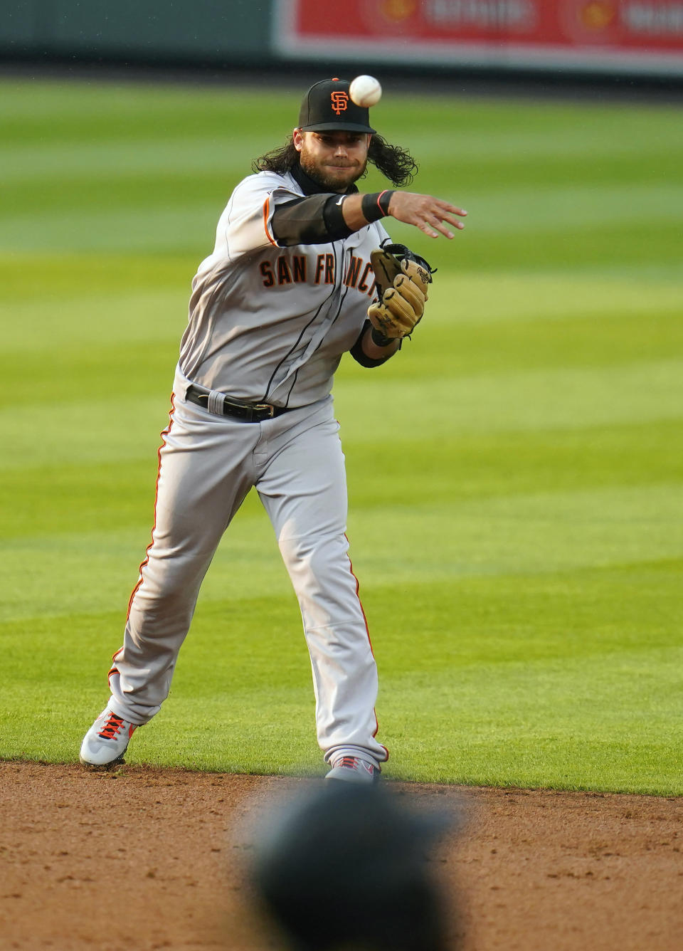 San Francisco Giants shortstop Brandon Crawford throws to first for the out against Colorado Rockies' Raimel Tapia during the second inning of a baseball game, Wednesday, Aug. 5, 2020, in Denver. (AP Photo/Jack Dempsey)