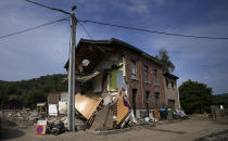 The side of a house is collapsed in the village of Trooz, Belgium, Tuesday, July 27, 2021. Three people have been left dead in the small village and nearly half of it's residents have sustained damage to their homes (AP Photo/Virginia Mayo)