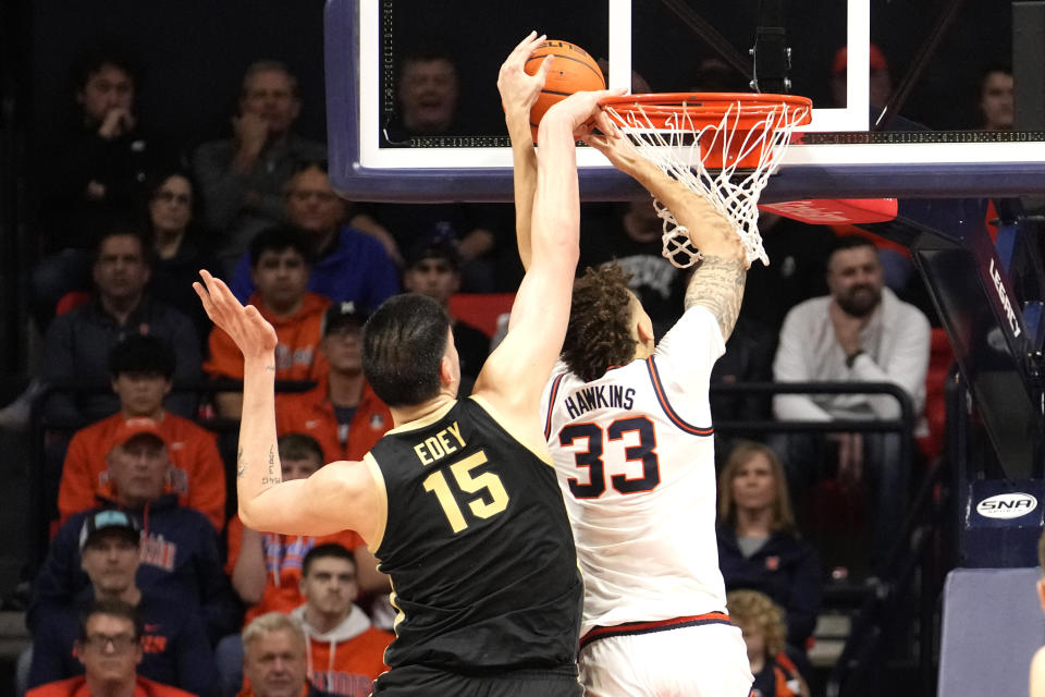 Purdue's Zach Edey (15) blocks a dunk attempt by Illinois' Coleman Hawkins during the second half of an NCAA college basketball game Tuesday, March 5, 2024, in Champaign, Ill. Purdue won 77-71. (AP Photo/Charles Rex Arbogast)