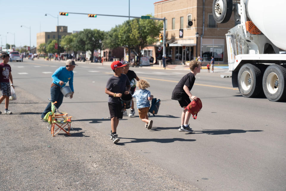 Children make a mad dash for candy at the 104th annual Wheatheart of the Nation Parade Saturday in Perryton.