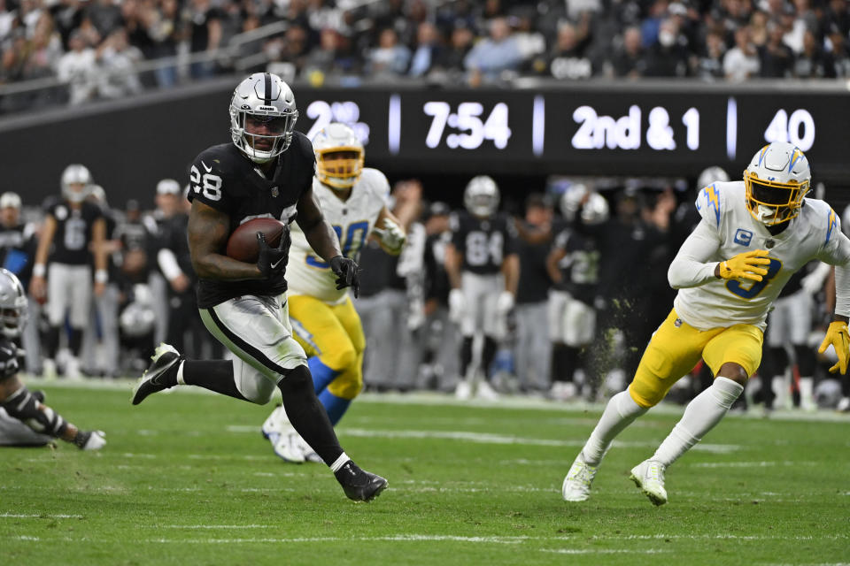 Las Vegas Raiders running back Josh Jacobs (28) carries for a touchdown during the first half of an NFL football game against the Los Angeles Chargers, Sunday, Dec. 4, 2022, in Las Vegas. (AP Photo/David Becker)