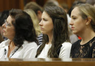 Sister of Oscar Pistorius Aimee Pistorius, center, attends his murder trial as chief prosecutor Gerrie Nel questions Oscar Pistorius in court in Pretoria, South Africa, Monday, April 14, 2014. Pistorius who is charged with the murder of his girlfriend Reeva Steenkamp on Valentine's Day in 2013, is being cross-examined at his trial for the fourth day by Nel. (AP Photo/Kim Ludbrook, Pool)