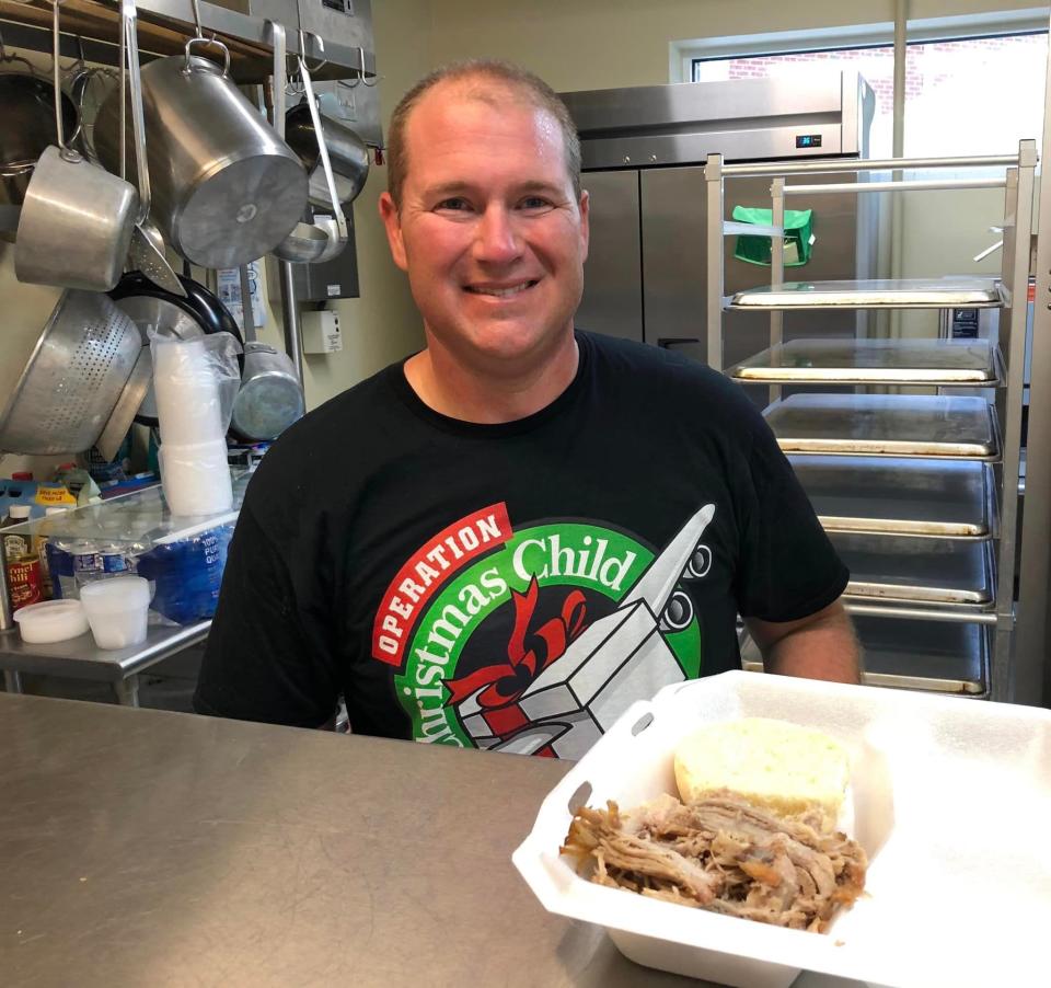 Matt Stinson serves barbecue he and his father Les Stinson made to help raise money for Second Branch Baptist's mission to raise funds for Operation Christmas Child.