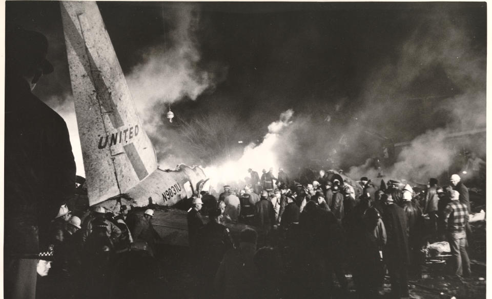 ** FILE ** Firefighters are shown in a file photo as they work to smother smouldering debris after a United Airlines jet crashed at Midway Airport in Chicago on Dec. 8, 1972. The jet struck tree branches about a mile from the airport, then hit the roofs of a number of bungalows before plowing into a home, bursting into flames. The crash killed 45 people, two of them on the ground. Eighteen passengers survived. (AP Photo/File)