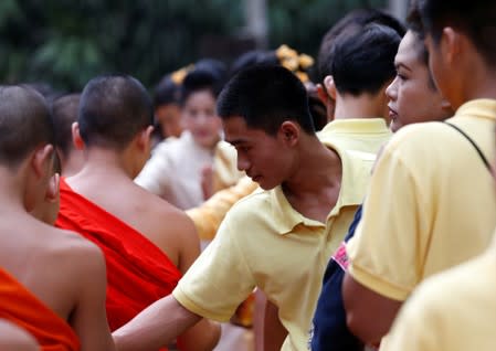 Members of the Wild Boars soccer team return one year after their rescue from the caves in Tham Luang