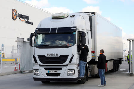 FILE PHOTO: Pickets talk to a truck driver who was driving out of an Amazon fulfillment centre in San Fernando de Henares near Madrid, Spain, November 23, 2018. REUTERS/Susana Vera/File Photo