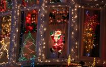 MELKSHAM, ENGLAND - DECEMBER 08: Christmas festive lights adorn a detached house in a suburban street in Melksham, December 8, 2012 in Melksham, England. The lights, a popular festive attraction, have returned to the town after a two-year absence and have raised thousands of pounds for charity for a local hospice, Dorothy House. The display, which is estimated to involve over 100,000 bulbs, worth over 30,000 GBP and even needed an up-rated electricity supply installed to cope with the additional power needed, is the brainchild of householder and electrician Alex Goodhind. This year, the display which Mr Goodhind began fifteen years ago now takes a team of professional electricians five weeks to complete, and even includes a snow machine. (Photo by Matt Cardy/Getty Images)