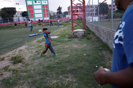 Jesus Cordova (C), practices baseball in Caracas, Venezuela August 29, 2017. REUTERS/Carlos Garcia Rawlins/Files