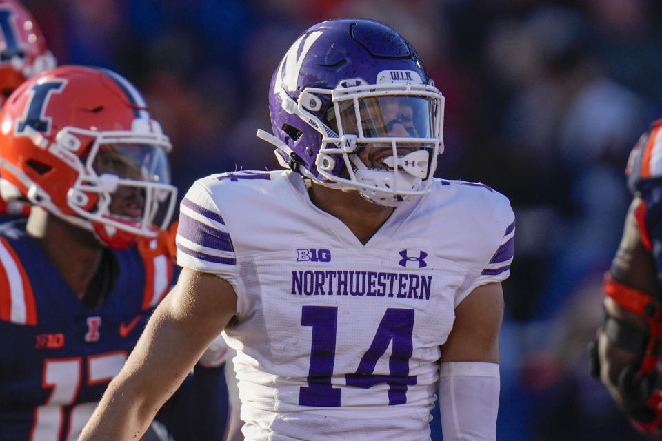 Northwestern wide receiver Cam Johnson (14) celebrates after his touchdown during the first half of an NCAA college football game against Illinois, Saturday, Nov. 25, 2023, in Champaign, Ill. (AP Photo/Erin Hooley)