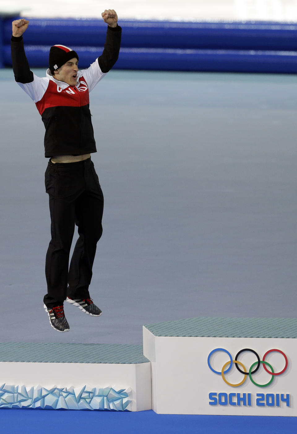 Silver medallist Canada's Denny Morrison jumps in celebration during the flower ceremony for the men's 1000-meter speedskating race at the Adler Arena Skating Center during the 2014 Winter Olympics in Sochi, Russia, Wednesday, Feb. 12, 2014. (AP Photo/Patrick Semansky)