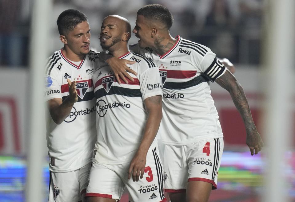 Patrick of Brazil's Sao Paulo, center, celebrates scoring his side's second goal against Brazil's Atletico Goianiense during a Copa Sudamericana semifinal second-leg soccer match at Morumbi stadium in Sao Paulo, Brazil, Thursday, Sept. 8, 2022. (AP Photo/Andre Penner)