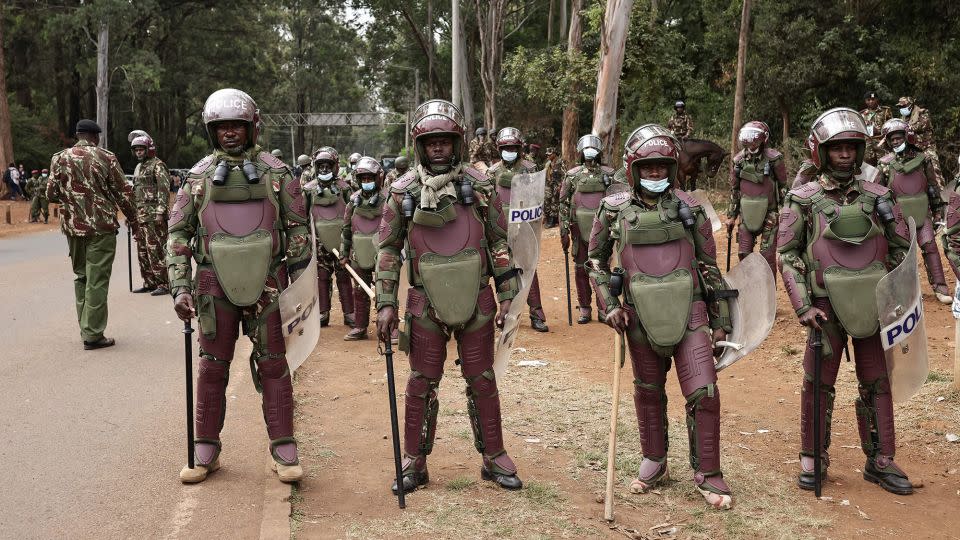 Kenyan police officers wearing riot gear stand on the side of the road near Bomas in Nairobi in August 2022, while waiting for the results of the country's general election. - Patrick Meinhardt/AFP/Getty Images