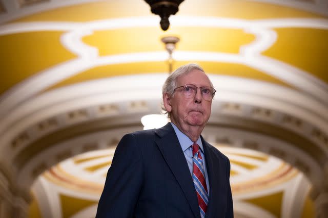 <p>Drew Angerer/Getty Images</p> Senate Minority Leader Mitch McConnell arrives at a news conference on July 26, 2023. At the podium a short time later, he froze and stopped speaking