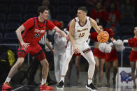Charleston forward Ante Brzovic (10) handles the ball against Stony Brook center Keenan Fitzmorris (32) during the first half of an NCAA college basketball game in the championship of the Coastal Athletic Association conference tournament, Tuesday, March 12, 2024, in Washington. (AP Photo/Terrance Williams)